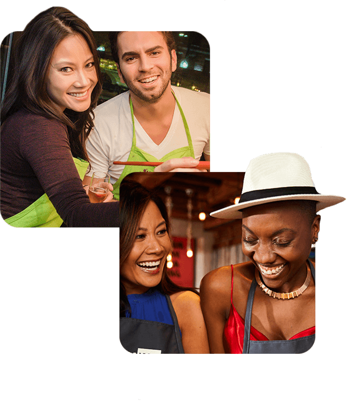 Paint Nite couples painting class - man and woman smiling in Paint Nite aprons, women laughing together