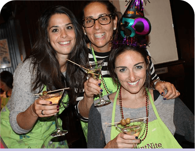 Friends celebrating at private paint and sip events with personalized art projects and party atmosphere
