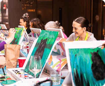 Paint and sip experience featuring paintings and group activities