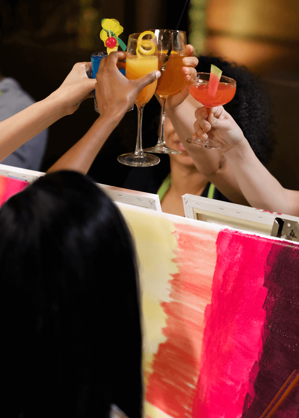 Paint Nite Event - Two women smiling and having fun at Paint Nite paint and sip party