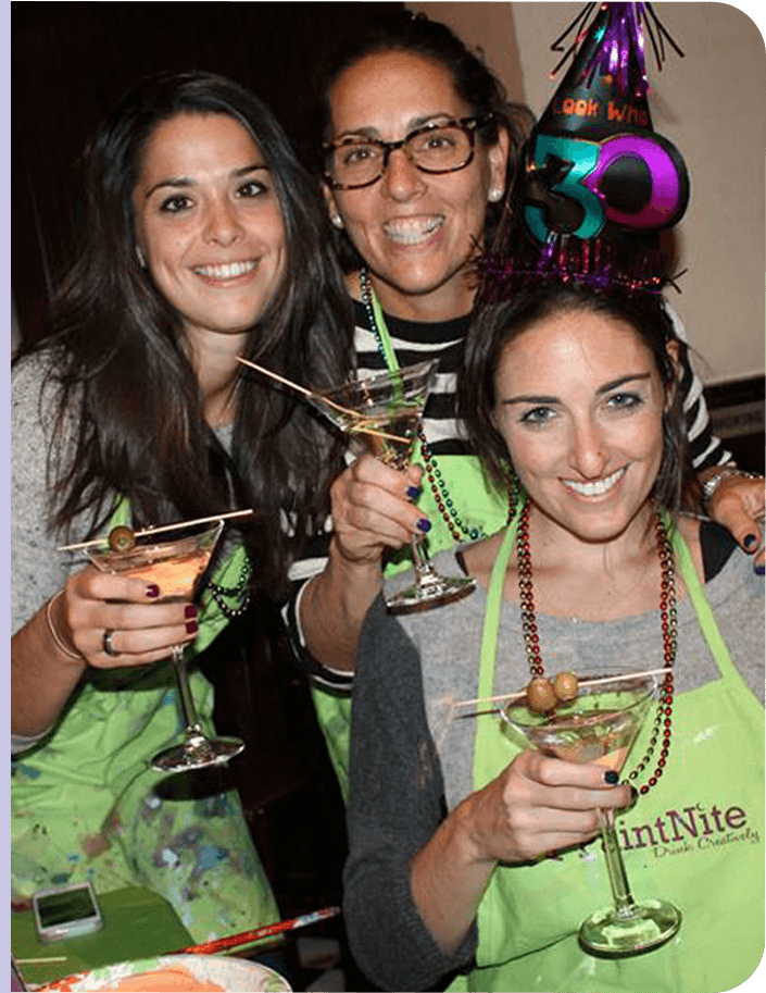 Friends celebrating at private paint and sip events with personalized art projects and party atmosphere